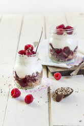 Two glasses of granola dessert with raspberries, yoghurt and quinoa - SBDF001698