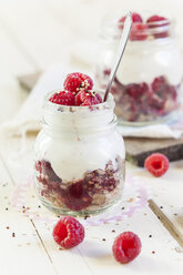 Glass of granola dessert with raspberries, yoghurt and quinoa - SBDF001699