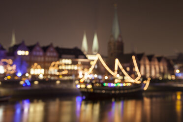 Germany, Bremen, blurred view to lighted historic old town at night - WIF001626