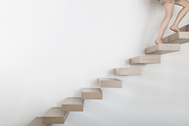 Woman walking on floating staircase - PDF000898