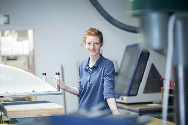 Portrait of confident young female shoemaker in workshop - SGF001462