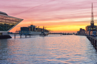 Germany, Hamburg, container ship and Dockland building at sunset - RJF000415