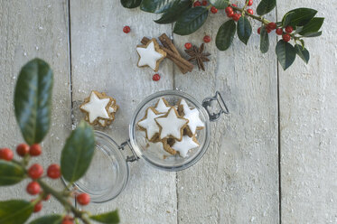 Glass of cinnamon stars and Christmas decoration - ASF005513