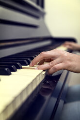 Hands of woman on old piano - MIDF000235