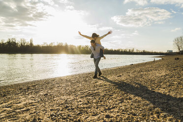 Happy young couple having fun at the riverside - UUF003765