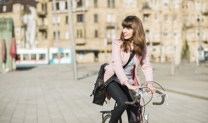 Young woman with bicycle in the city - UUF003807