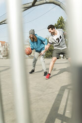 Couple playing basket ball - UUF003841