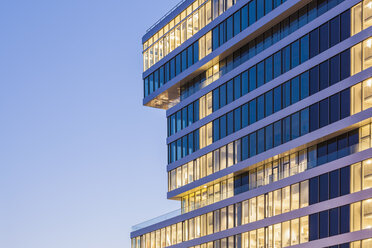 Germany, Renningen, facade with lighted windows of Center for Research and Advance Development - WDF003050