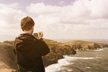 Portugal, Azores, man taking picture of coastal landscape - ONF000800