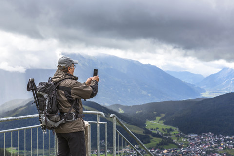 Austria, Seefeld in Tirol, Schlossberg, man taking picture stock photo