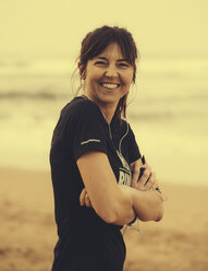 Spain, Gijon, Woman sitting at beach - MGOF000186