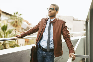 Portrait of businessman wearing leather jacket and glasses - EBSF000526