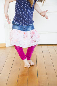 Girl dancing on wooden floor - LVF003158