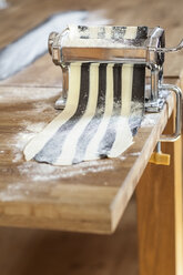 Making striped pasta in pasta machine, partly colored with cuttlefish ink - SBDF001765