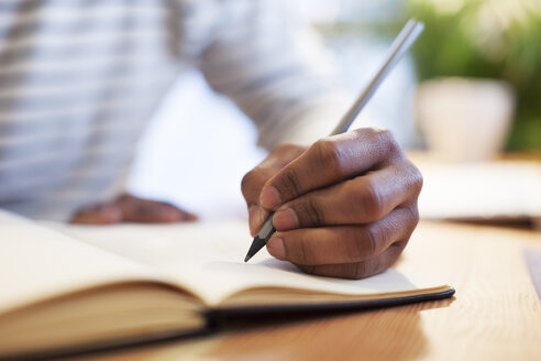 Man's hand drawing in a notebook - EBSF000544