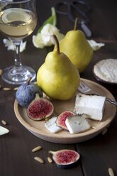 Variety of cheese, wine, pears, figs and pine nuts - YFF000360