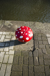 Netherlands, Rotterdam, bollard formed like a fly agaric on a quay - MYF000983