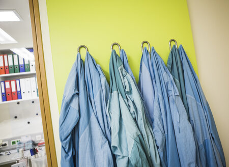 Lab coats hanging on coat hook - DISF001607