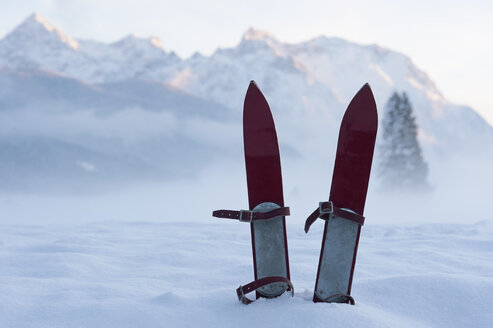 Germany, Bavaria, pair of children's ski in snow in front of Karwendel mountains - ASF005551