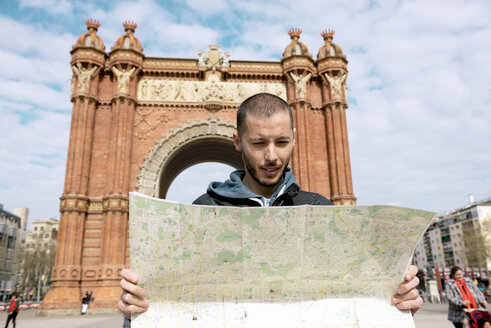 Spanien, Barcelona, Mann schaut auf Stadtplan vor Trymphalbogen - GEMF000182