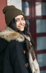 Portrait of happy young woman wearing wool cap - MGOF000199