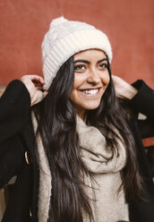 Portrait of happy young woman wearing wool cap - MGOF000197