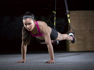 Young woman doing suspension training - MADF000186