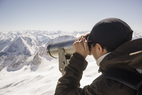 Germany, Bavaria, woman looking through telescope at Zugspitze - FLF001027