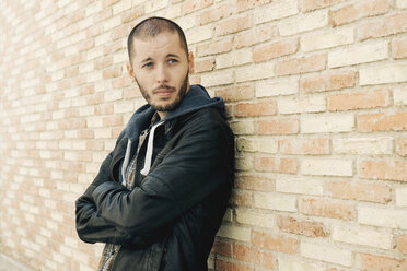 Portrait of man leaning on brick wall - GEMF000189