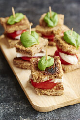 Caprese salad on toast with tomato, non-dairy mozarella type cheese and a basil leaf - HAWF000768