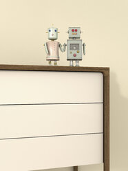 Männlicher und weiblicher Roboter auf einem Sideboard, 3D-Rendering - UWF000424