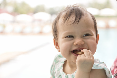 Happy baby girl eating pizza stock photo