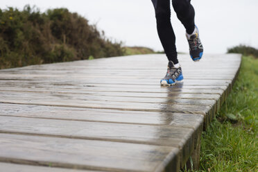 Jogger läuft auf nasser Promenade - RAEF000124