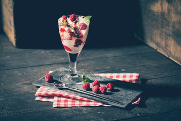 Glass of Bourbon vanilla ice with hot raspberries and chocolate sauce - MAEF010272