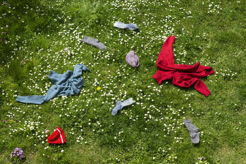 Winter clothes lying scattered in spring meadow - MIDF000323