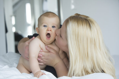 Mother kissing baby girl - JTLF000102