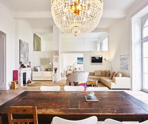 Living room in a refurbished old building with dining table in the foreground - DISF002034