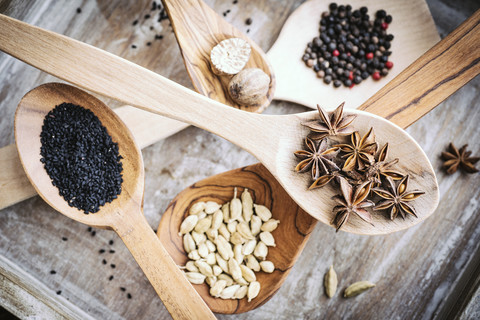 Different spices on wooden spoons stock photo