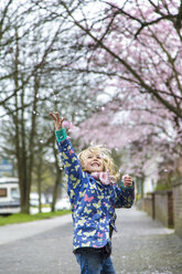 Little girl throwing cherry blossoms in the air - JFEF000626