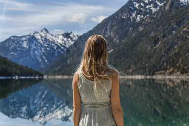 Austria, Tyrol, Lake Plansee, woman at lakeshore - TCF004603