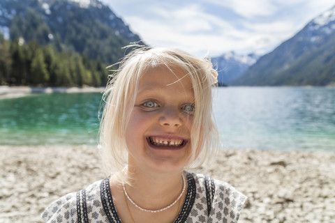 Austria, Tyrol, Lake Plansee, portrait of happy girl stock photo