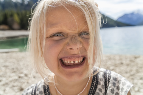 Austria, Tyrol, Lake Plansee, portrait of girl pulling a face stock photo