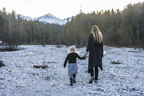 Germany, Bavaria, Lindergriess, mother and daughter walking in dry creek bed - TCF004609