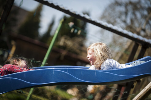 Two happy girls on a slide - PAF001300