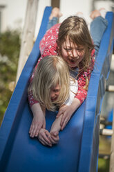 Two happy girls on a slide - PAF001301