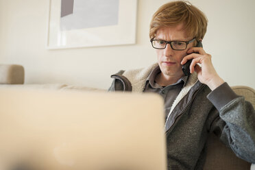 Man with laptop on the phone - PAF001305