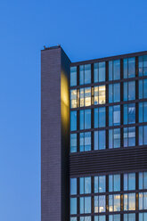 Germany, Baden-Wuerttemberg, Stuttgart, facade of office building at twilight - WDF003082