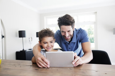 Father and son using digital tablet - TOYF000053