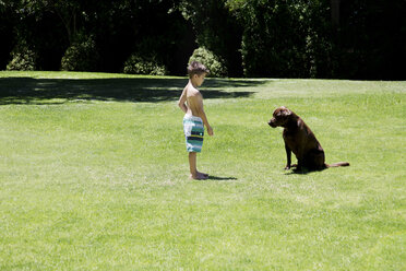 Junge spielt mit Hund im Garten - TOYF000069