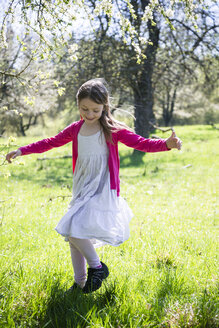 Girl dancing on a meadow in springtime - SARF001745